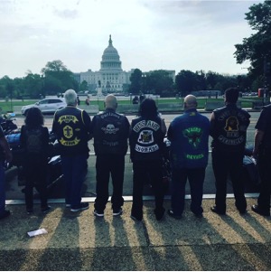 Motorcyclists stand in front of the Capitol Building in Washington, D.C.
